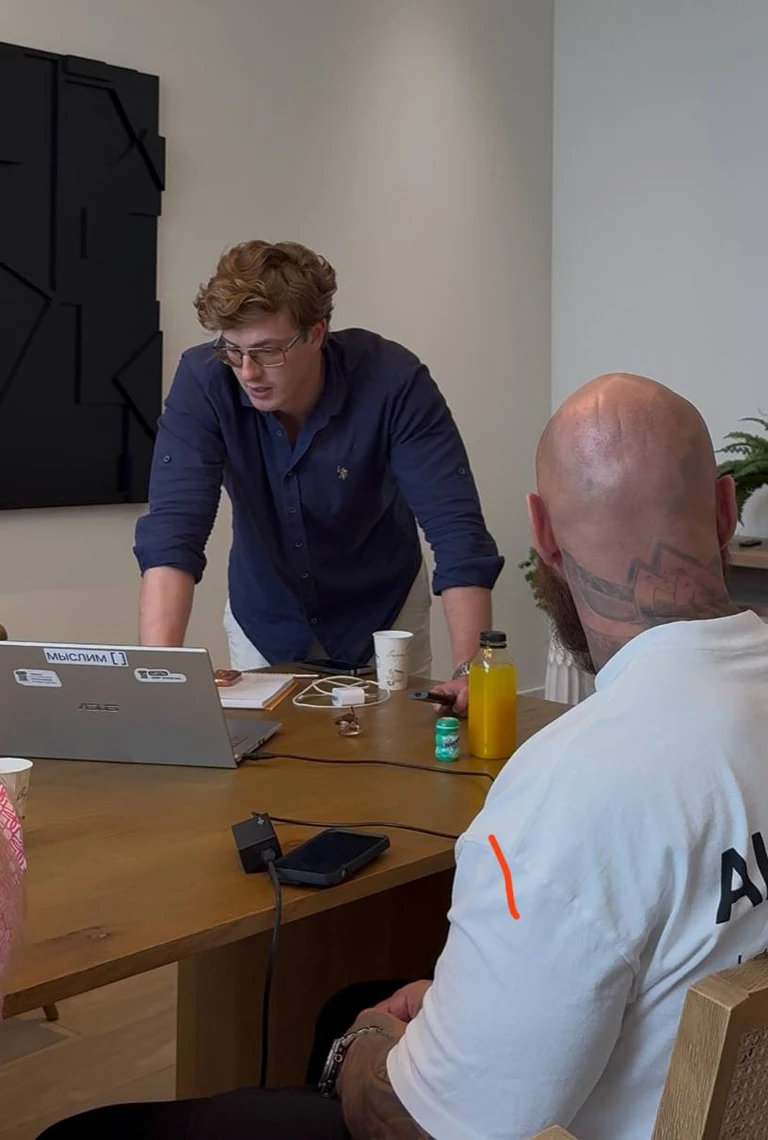 Maxim reviewing a client's plan over a laptop